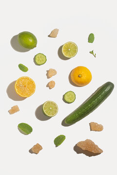 Lemon lime cucumber rock sugar mint on white background with shadow clean sunlit look