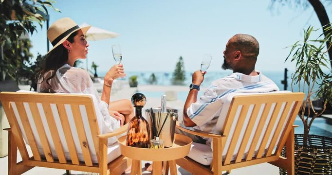 Interracial couple, back and relax with champagne or cheers for vacation, summer holiday or date at luxury resort. Man, woman or lovers with toast by pool for drink, anniversary or honeymoon together