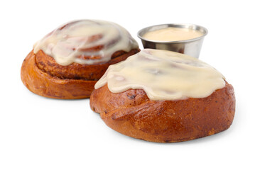 Tasty cinnamon rolls with cream isolated on white