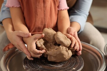 Hobby and craft. Mother with her daughter making pottery indoors, closeup