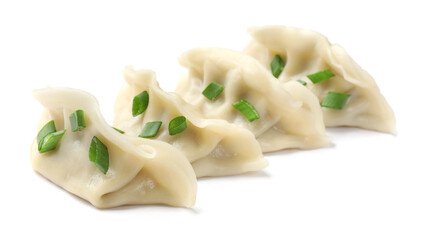 Fresh gyoza dumplings with pieces of green onion isolated on white