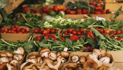 Fresh vegetables at small local urban market. Organic produce on sale at outdoor farmer market. Selling fresh crops and veggies harvest. European urban setting. Close up. Part of the series