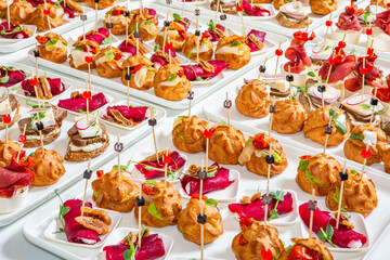 Catering buffet or service with different snacks, appetizers and canapes on a table. Variety of Freshly Prepared Catering Food for an Event.