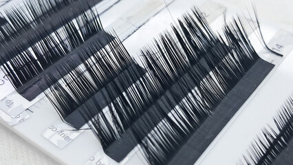 Close up of eyelash extensions and professional tools for application.
