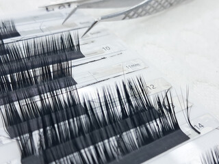 Close up of eyelash extension products and tools for precise application.