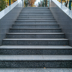 Fototapeta premium Granite steps leading upwards in autumn park; background shows trees and path. Website banner or blog post image