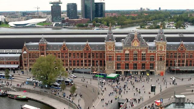 Beautiful aerial cinematic footage of the Amsterdam Centraal Train Station  A historic hub with canals, bikes, cafes, and stunning city views all around Amsterdam