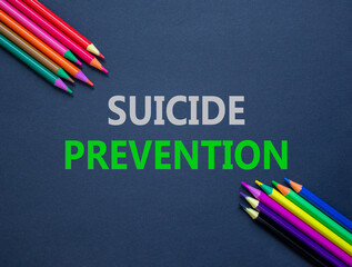 Suicide prevention symbol. Concept words Suicide prevention on beautiful black paper. Colored...