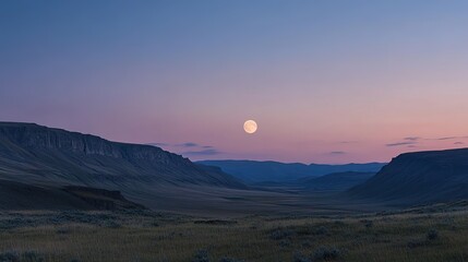 Fototapeta premium Moonlit landscape over a vast mountain valley at dusk