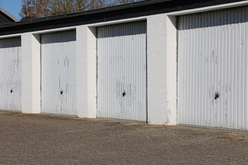 close-up of a row of closed white garage doors