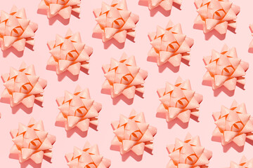 Peach pink paper bows, gifts or presents, elegantly packed, creative holiday wallpaper