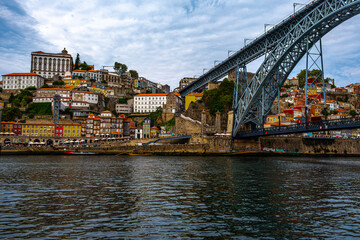 Obraz premium Stunning view in clear weather of the town with lovely houses opposite over the river and bridge on the side
