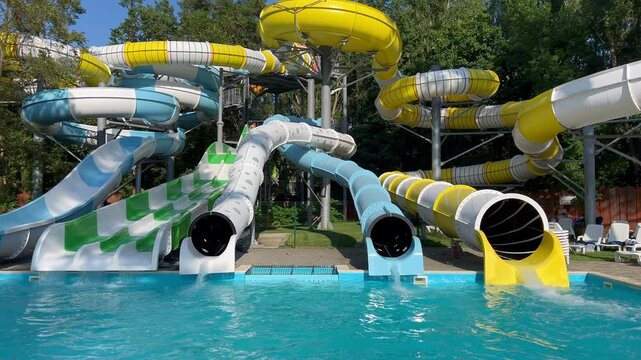 Tourists sliding down water slides at water park