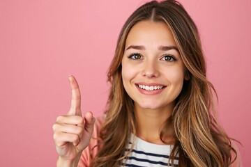 Young Woman Smiling and Pointing Up with a Pink Background
