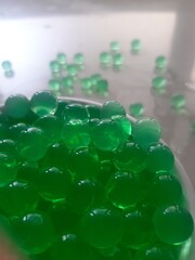 Green glass balls, close up of a green glass beads, green glass beads, green bubble, green pearl...