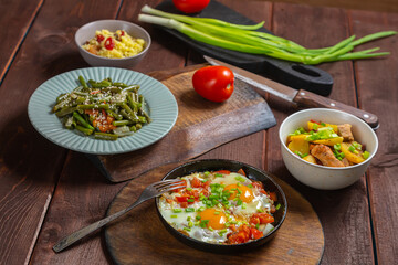 Set table, Jewish food, tzimmes, chelnt, shakshuka and couscous