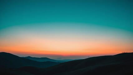 Obraz premium Mountains silhouetted against a gradient sky