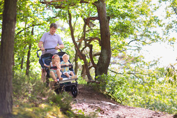 Father with children in all terrain stroller