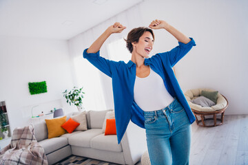 Photo of positive good mood girl dancing home alone have fun modern interior new apartment