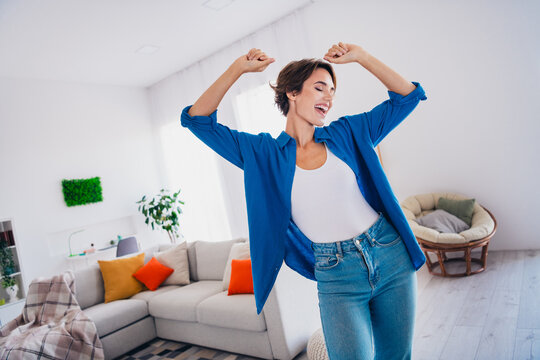 Photo of positive good mood girl dancing home alone have fun modern interior new apartment