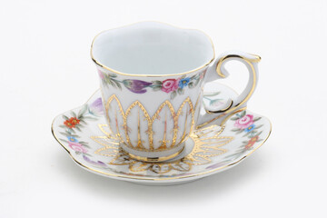 Small, decorated tea cup and saucer perfect for an afternoon tea party