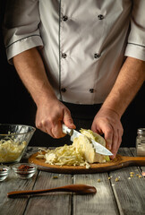 In a cozy kitchen, a chef expertly chops fresh cabbage, showcasing culinary skills. Surrounded by spices and utensils, the atmosphere is warm and inviting, perfect for cooking enthusiasts