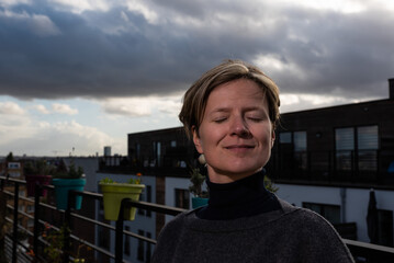 Portrait of an attractive thirty year old woman sitting on a terrace, Jette, Belgium