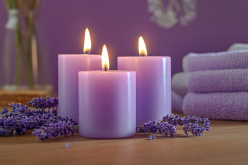 Burning candles with lavender flowers. Spa and Wellness background in purple and violet colors