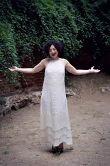 Jazz singer, dressed in a white 1920s party dress singing and dancing.
