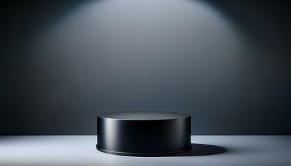 a black pedestal with a circular base and a grey wall behind it