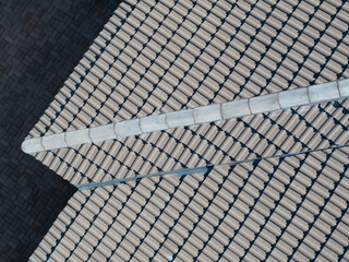 repairs concrete roof tiles, house roof, roofing plans, renovation and maintenance of roof tiles, restoration and repairs of leaks on shingles edges, top down aerial view, © poco_bw