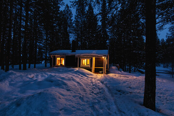 Cozy wooden cabin in a snow-covered forest in the north of Sweden, Kiruna