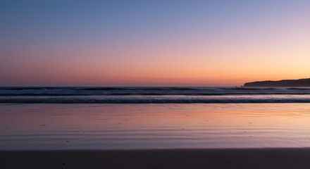 Obraz premium Calm Ocean Beach at Dusk with Soft Waves and Sky Reflection