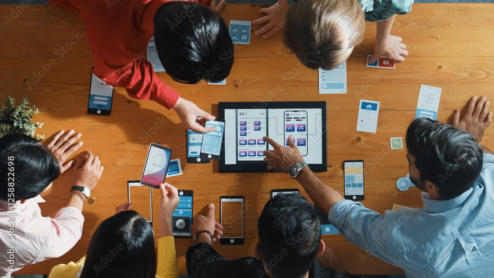Poster top down view of business team writing idea on sticky note while planing for ux ui design for mobile