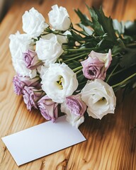 Fototapeta premium Delicate flowers are elegantly arranged next to a blank greeting card, creating a tender and romantic composition