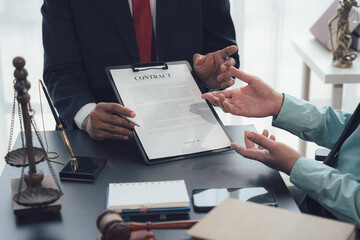Legal Consultation: A lawyer confidently explains a contract to a client, emphasizing key legal points in a professional and trustworthy setting. The image conveys trust and expertise. 