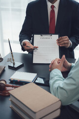 Contract Negotiation: A lawyer in a tailored suit discusses the legal terms of a contract with a...