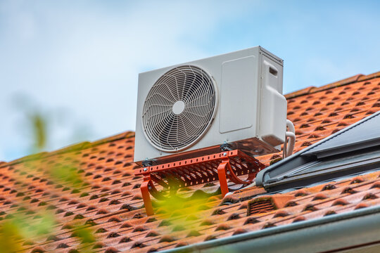Dual inverter compressor, combination of air conditioner compressor and heating pump, installed on a roof of family house