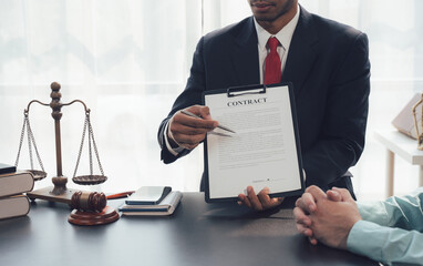 Legal Counsel: A lawyer in a professional suit meticulously reviews a legal document with a client,...