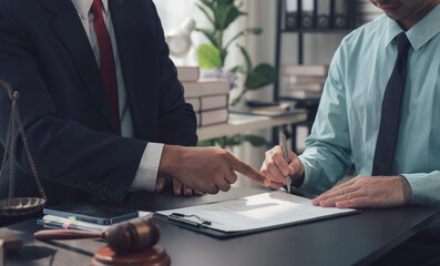 Legal Contract Signing:  A close-up shot showing two professionals, likely a lawyer and client.