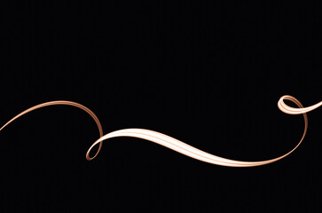 Graceful flowing light patterns dance across a dark background, creating captivating visual effects in an artistic display