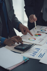 Financial Analysis Meeting: Close-up shot of hands actively engaged in reviewing financial data,...