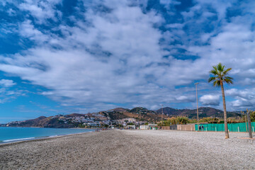 Playa de Playazo Nerja beach Spain Costa del Sol Andalusia blue sky and mediterranean sea and waves
