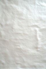 Obraz premium Textured white surface with subtle patterns visible under natural light in an indoor setting