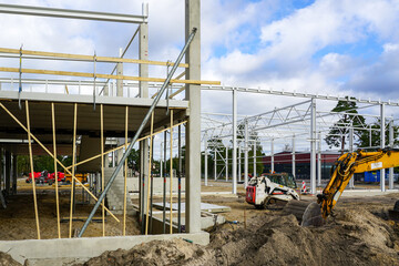 Construction site of a new modern factory reinforced concrete and metal structure building frame