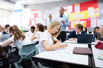 Classroom with diverse students and a teacher. Students, teacher, and classroom environment,...