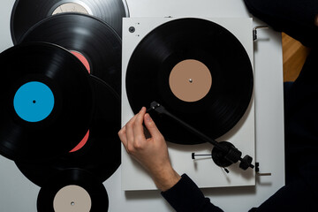 Vinyl record is playing a vintage vinyl album in the music studio. Listening rock vinyl album by...