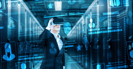 Fototapeta premium Business man looking at security system hologram and standing at data center. Skilled project manager checking and verify identity and accessing network security. Technology innovation. Ingenuity.