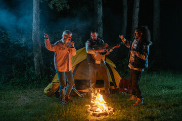 Singing and dancing next to a campfire