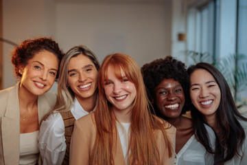 Five happy businesswomen in their office